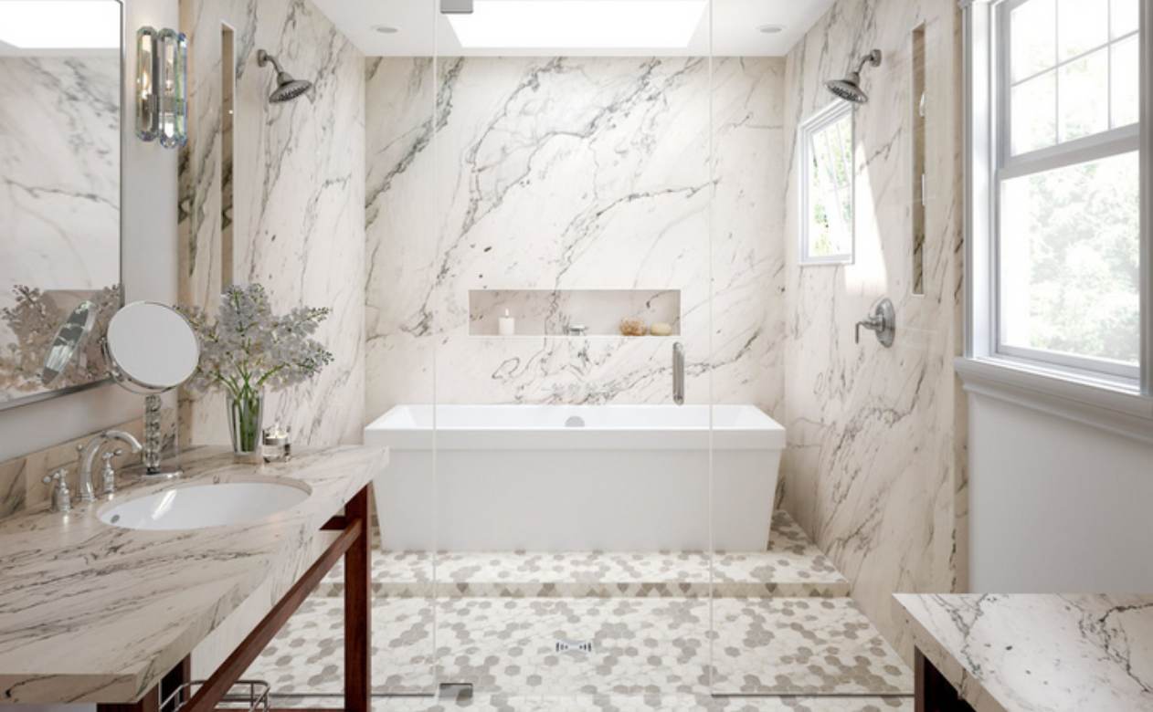 marble attache calacatta hex mosaic flooring by Daltile in bathroom with marble shower and bathtub.